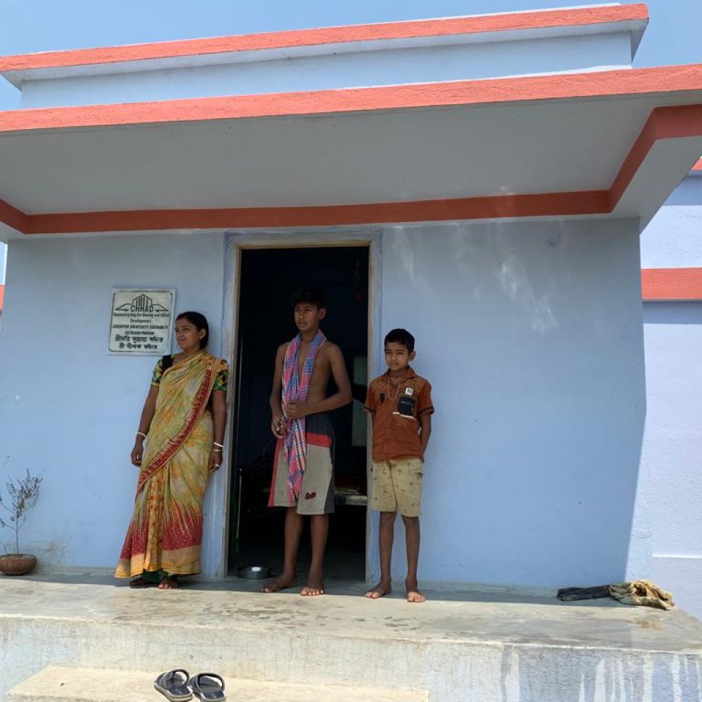 Beneficiary family in front of completed house